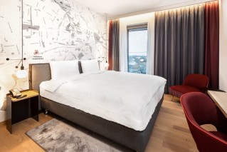 View of a modern IntercityHotel room during daytime