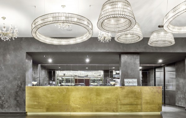 Reception area with modern chandeliers in a MAXX by Deutsche Hospitality hotel 